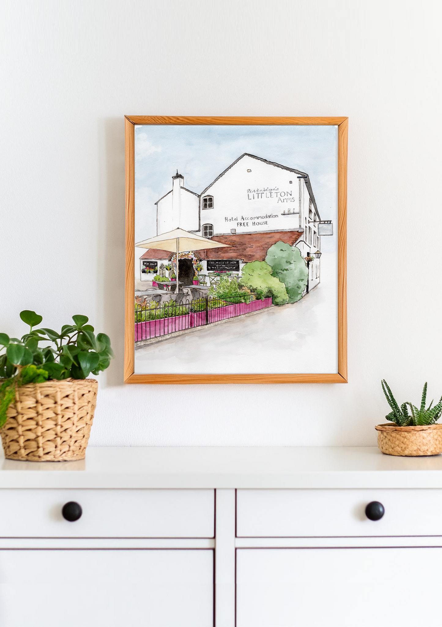 A ink and watercolour illustration of a pub framed