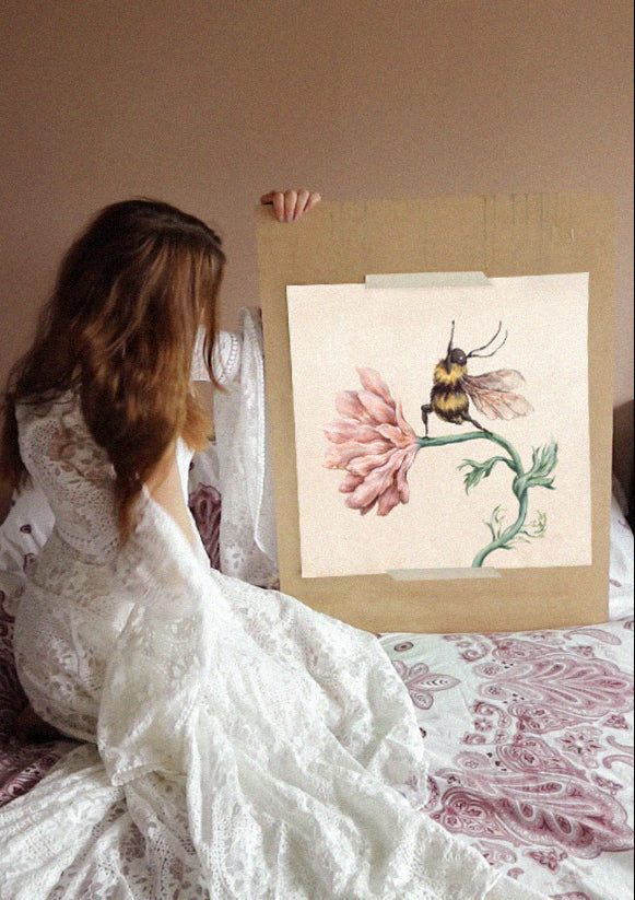 a print of a watercolour yoga bee illustration held by the artist