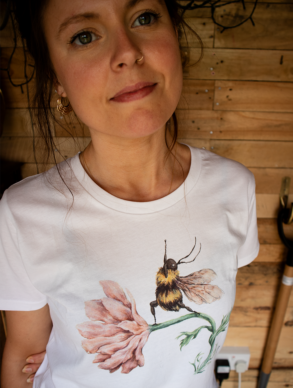 a cotton t-shirt with a print of a watercolour yoga bee illustration worn by the artist
