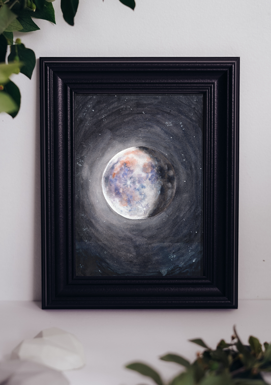 Framed print of a watercolor moon painting in the night sky