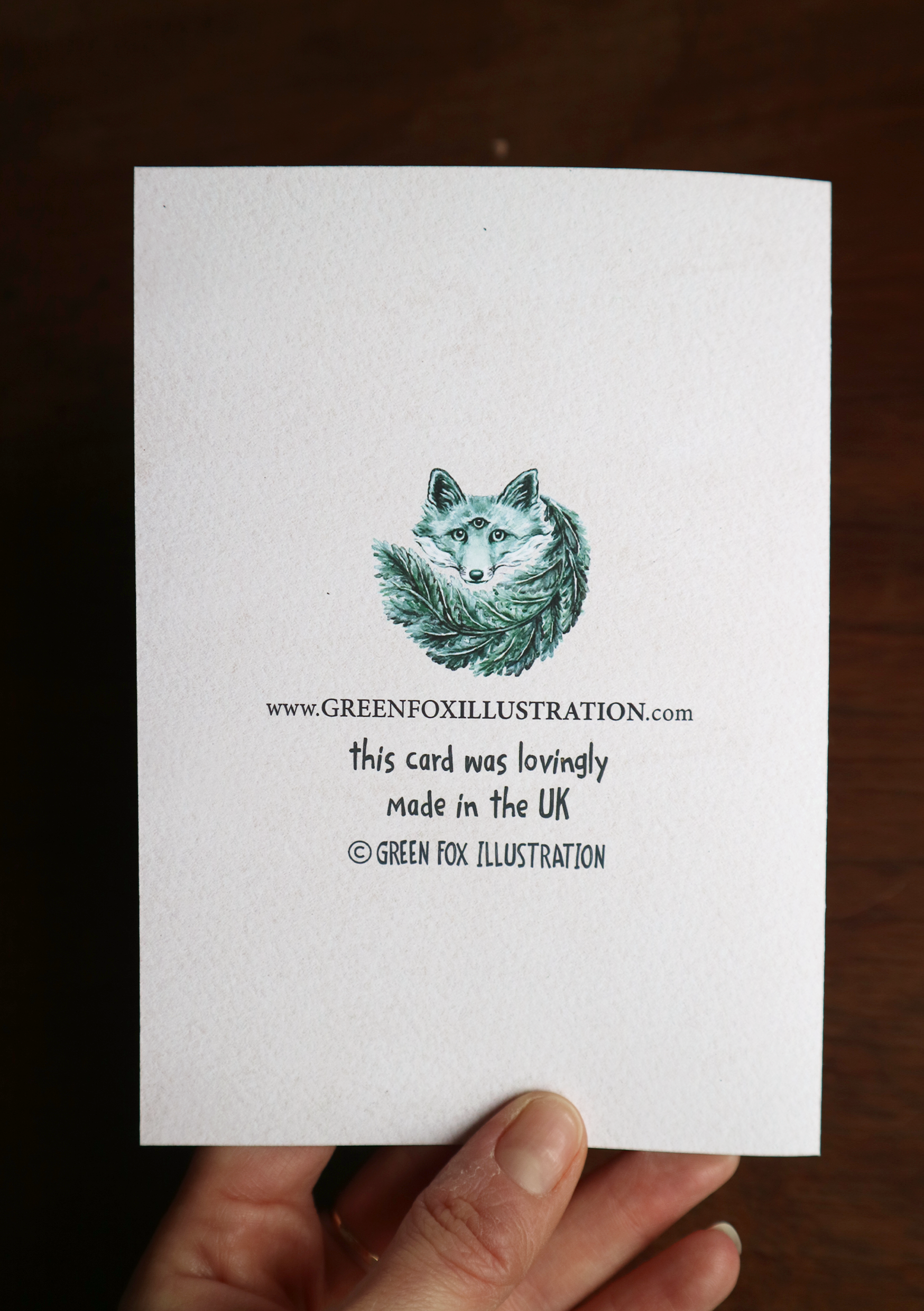 the back of a green fox illustration greetings card
